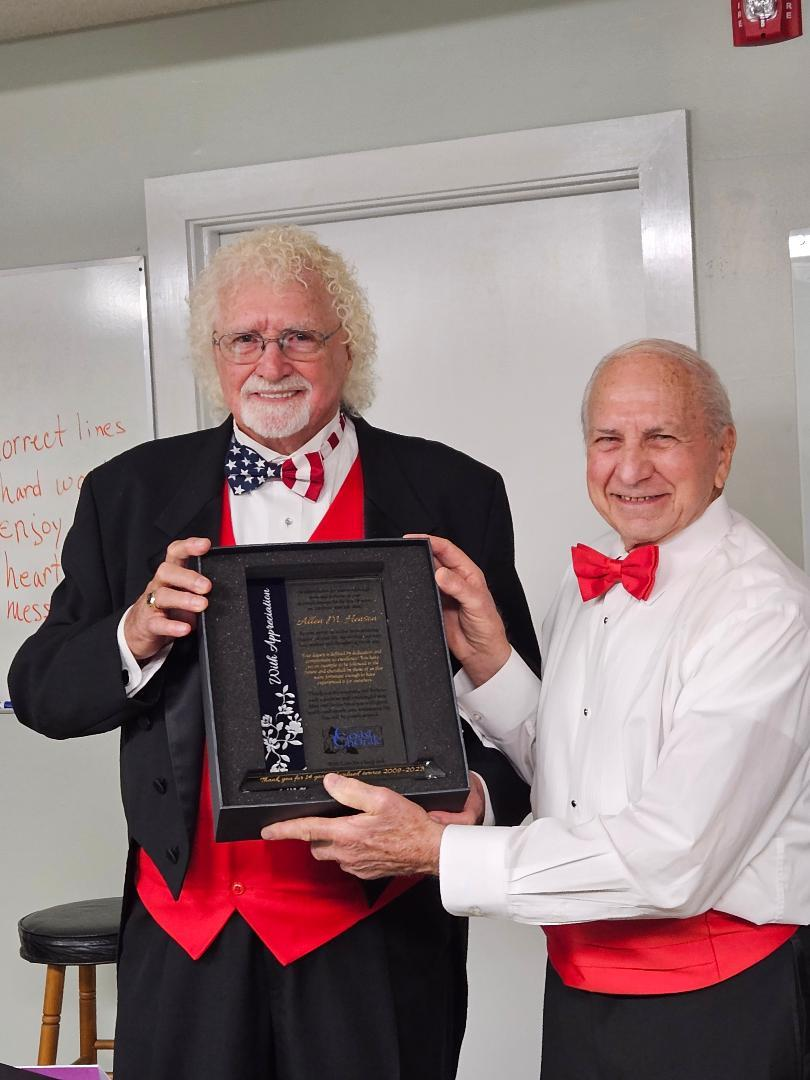Mr. Dan Seliga, Chairman of the Board
for Coast Chorale Presents Lifetime Achievement Award to Mr.
Allen Henson, Artistic Director of Coast Chorale Mr. Dan
Seliga, Chairman of the Board for Coast Chorale Presents
Lifetime Achievement Award to Mr. Allen Henson, Artistic
Director of Coast Chorale